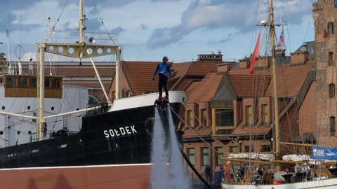 Flyboard man making dynamic tricks- August 2018, Gdansk, Poland  Stock Footage 96336354