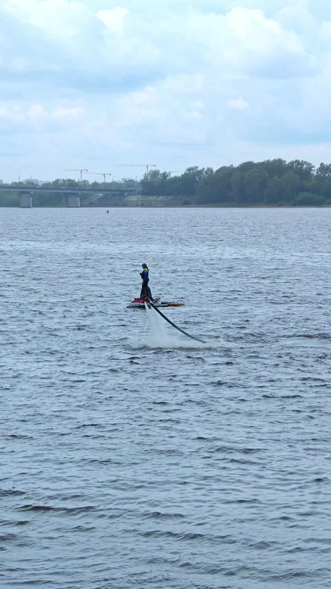 Flyboard. Water extreme. Flyboarder performs tricks over water. Stock Footage 289547689