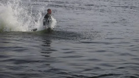 A flyboarder dived while performing stunts. Flyboarding, a new extreme sport. Stock-Footage 243409513