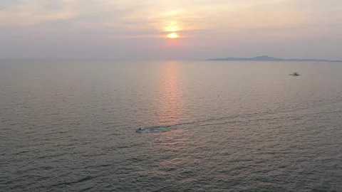 Flyboarder performing tricks at sunset over calm ocean Stock-Footage 311695588