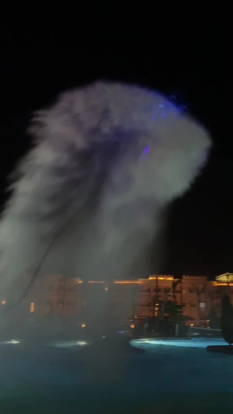 A flyboarder performs at an evening show at a resort pool. Stock Footage 282801252