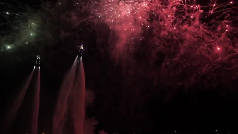 Flyboarding against the background of fireworks in the night sky, fireworks show Stock Footage 273951865