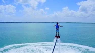 Flyboarding Over Blue Water With Jetski By Aerial Drone Stock Footage