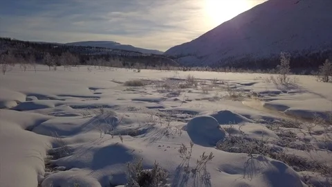 Flycam films white valley surface covered with snow and ice Stock Footage 112531880