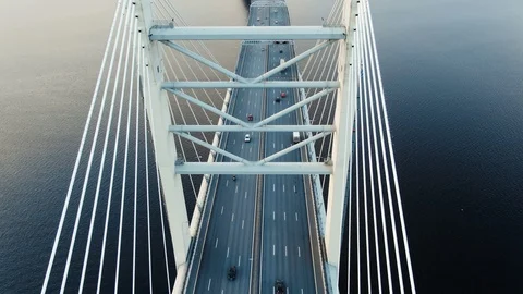 Flycam shows cable-stayed bridge pylons with cars downwards Stock Footage 109514229