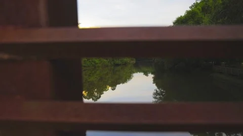 Flycam walking across Bridge looking at river Stock Footage 90354987