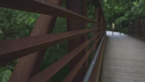 Flycam walking across Bridge looking metal beams Stock Footage 90355147