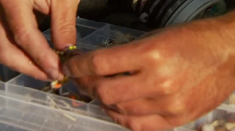 Flyfisher keeping baits in box Stock Footage 55334051