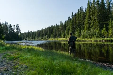 Flyfisherman casting in the river Foto stock