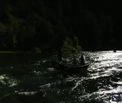Flyfishing drift boat passes camera Stock Footage 21651637