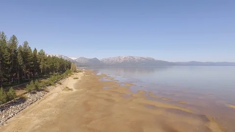 Flying 25 feet over beach at South Lake Tahoe. Stock Footage 90563853
