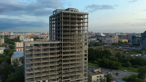 Flying a 4K drone around the construction site of a residential building under Video stock 113582663