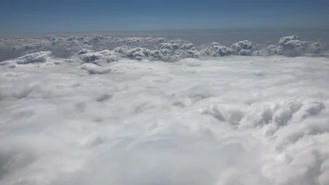 Flying above and then through fluffy white clouds in the sky Stock Footage 102350696