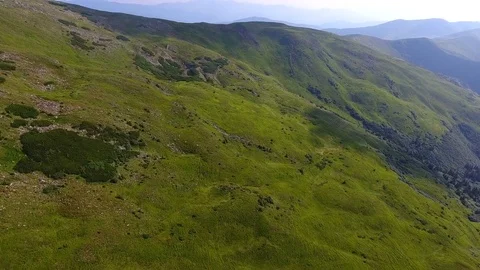 Flying above beautiful steep mountain hill at sunset Stock Footage 79890160