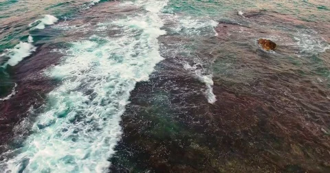 Flying above beautiful wavy seashore at evenng Stock Footage
