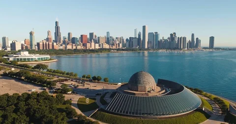 Flying above the buildings to reveal Chicago skyline panorama at lakefront Stock Footage