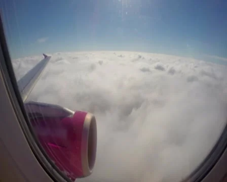 Flying above clouds, airplane wing turbine, passenger porthole, click for HD Stock Footage 43966574
