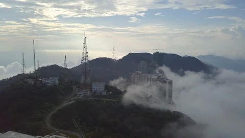 Flying above clouds and mountains past a radar tower Video stock 91088656