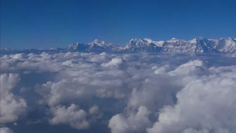 Flying above clouds and mountains along with the airplane propeller wings engine Stock Footage 247647178