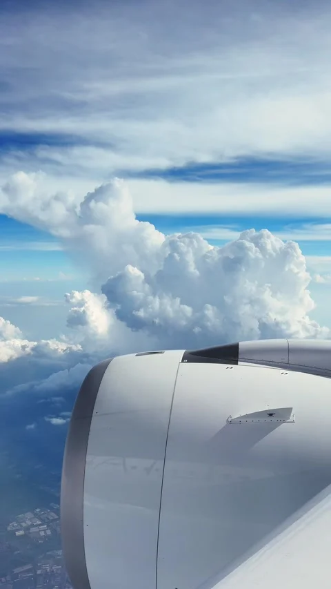 Flying above the clouds with a clear view from the airplane window on a sunny Video stock 305857087