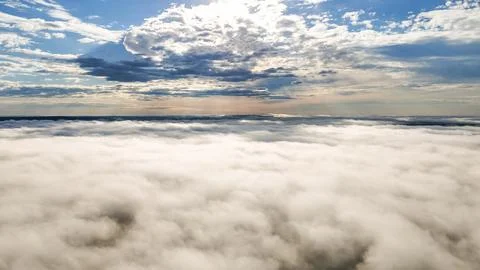 Flying above the clouds at dawn in autumn Stock Photos