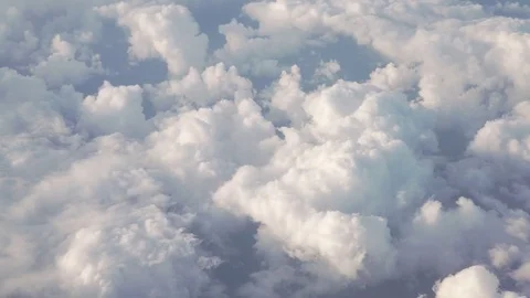 Flying above the clouds in daytime view form airplane window Stock Footage 83880665