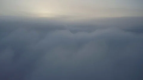 Flying above the clouds during sunset or sunrise Stock Footage 129060185