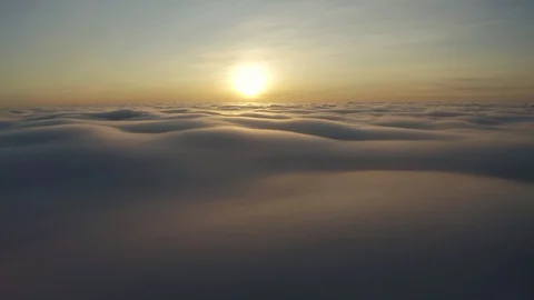 Flying above the clouds during sunset or sunrise Stock Footage 129060199