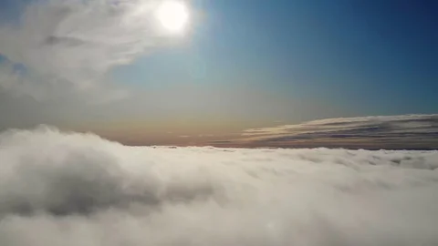 Flying above the clouds during sunset or sunrise 스톡 동영상 129099015