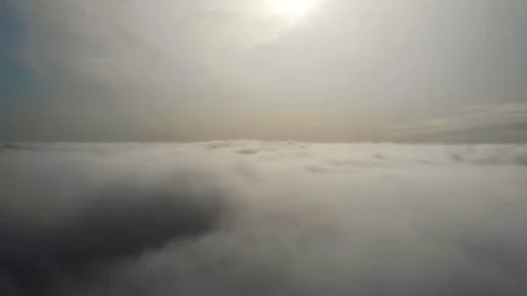 Flying above the clouds during sunset or sunrise Stock Footage 129099153