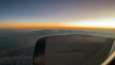 Flying above the clouds during sunset from aircraft window film, panning le.. 库存影片 333143281