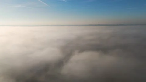 Flying above clouds fog scene blue skies sunshine enhancing perspective aerial Stock Footage 298189233