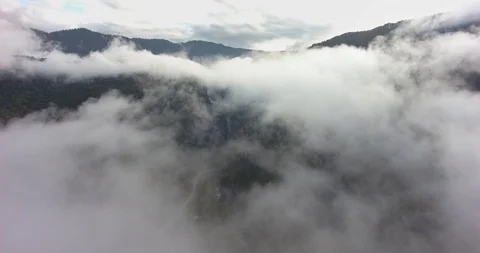 Flying above the clouds in the mountains Stock Footage 117768425