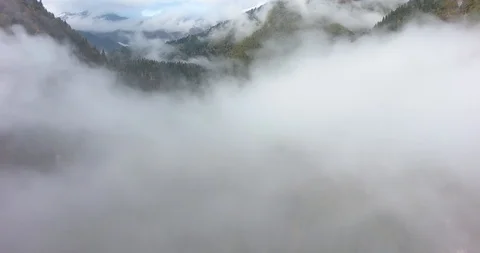 Flying above the clouds in the mountains Stock Footage 117768465