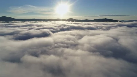 Flying above the clouds in the mountains. Landscape with sun, mountains and Video stock 138801616