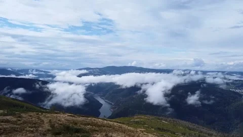 Flying above the clouds over beautiful countryside Stock Footage 205042432