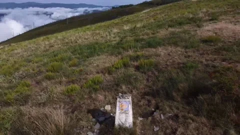Flying above the clouds over beautiful countryside past Camino sign Stock Footage 205042437