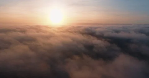 Flying above the clouds over the ocean at sunset aerial 스톡 동영상 153515469