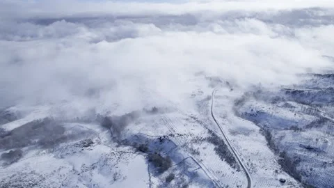 Flying above the clouds over a snowy landscape the concept of freedom and m.. 스톡 동영상 326701614
