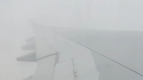 Flying above the clouds - Plane flying through cloudy sky window perspective, 4K Stock Footage 122662678