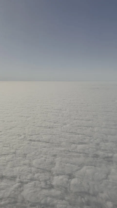 Flying above the clouds seen from an airplane window Stock Footage 327142173
