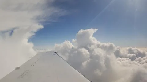 Flying above the clouds in the sun Stock Photos
