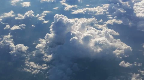 Flying above the clouds on a sunny day 4K Stock Footage 51444697