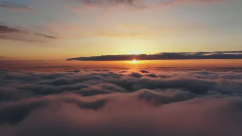 Flying above the clouds at sunset. Beautiful view of floating clouds at sunset. Video stock 118704160
