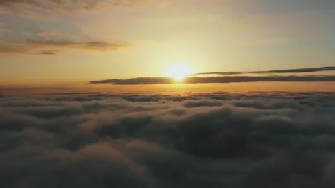 Flying above the clouds at sunset. Beautiful view of floating clouds at sunset. Stock-Footage 118704658