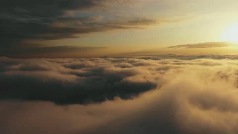 Flying above the clouds at sunset. Beautiful view of floating clouds at sunset. Video stock 118705034