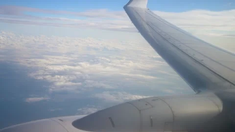 Flying Above Clouds With View of Airplane Wing in Afternoon Sky Stock Footage 311455495