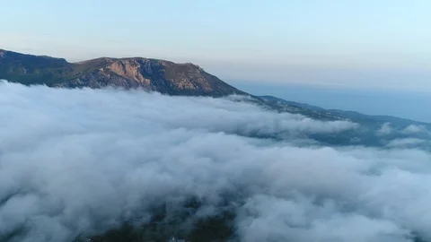 Flying above the Clouds With a View of the Towering Mountains. Top View. Crimea. Video stock 126267580