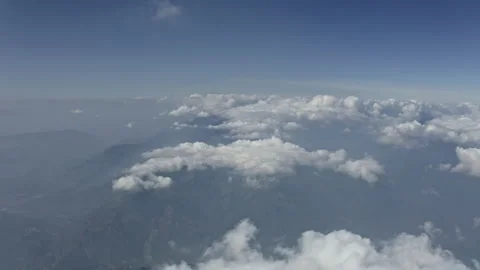Flying above the clouds, white puffy clouds are visible Stock Footage 169900243