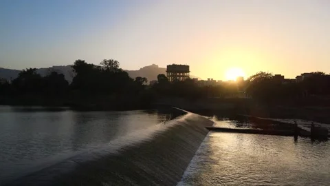 Flying above the dam and chasing the sunset from the sky Video stock 156489434